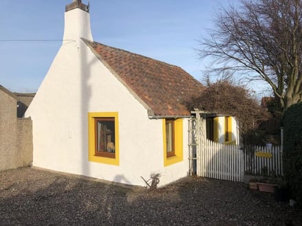 House with wall professionally painted with waterproof coating in white scotland