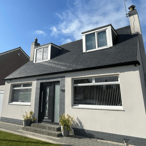 An example of the end result if you decide to refresh your home, showing a clean grey and beige-coloured house with freshly refurbished walls.