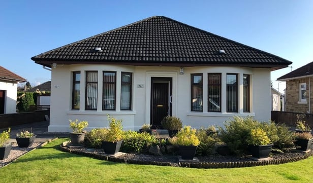 A house showcasing expertly refurbished exterior walls, demonstrating the advantages of refurbishment over complete replacement with new roughcasting.